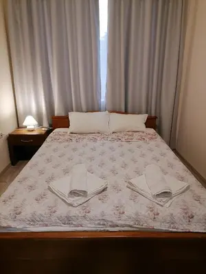 a bedroom with a bed with two towels on it at White home-apartament in Burgas City