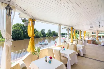 a restaurant with tables and a view of a river at Perla Sun Beach Hotel - All Inclusive in Primorsko