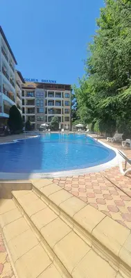 a large swimming pool in front of a building at Golden Dreams Apartment in Sunny Beach