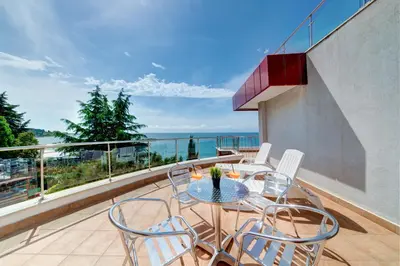a balcony with a table and chairs on a balcony at Petrov Family Hotel in Nesebar