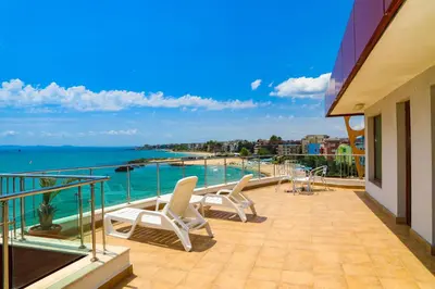 a balcony with chairs and a view of the ocean at Petrov Family Hotel in Nesebar