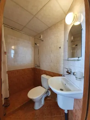 a bathroom with a toilet and a sink at Balaton Hotel in Sunny Beach