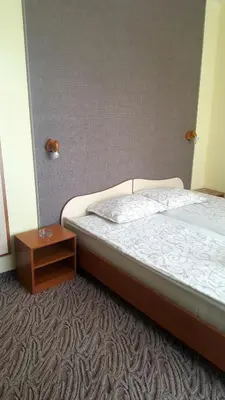 a bedroom with a bed and a small table at Balaton Hotel in Sunny Beach