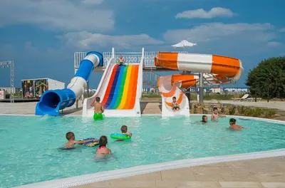 a group of children in a swimming pool at a water park at Sunrise Blue Magic Resort - All Inclusive in Obzor
