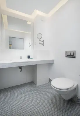 a white bathroom with a toilet and a sink at Sunrise Blue Magic Resort - All Inclusive in Obzor