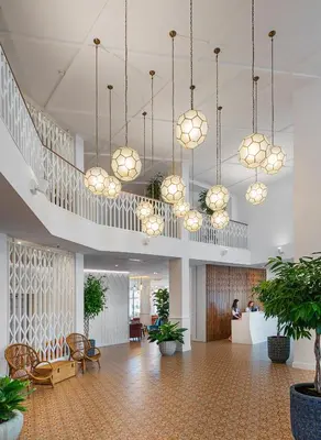 a lobby with potted plants and chandeliers at Sunrise Blue Magic Resort - All Inclusive in Obzor