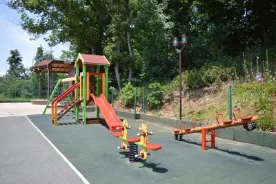 a playground with a slide and a play structure at Arkutino Family Resort in Sozopol