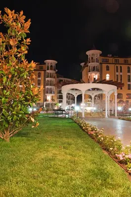 a park in front of a building at night at Royal Sun Apartments in Sunny Beach