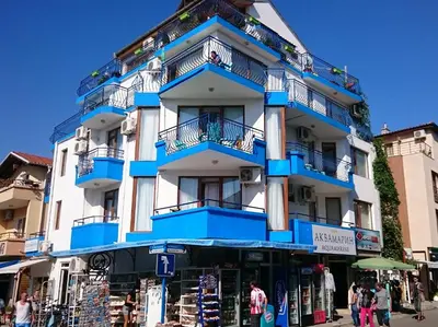 a building with blue balconies on a street at Aquamarine in Sozopol