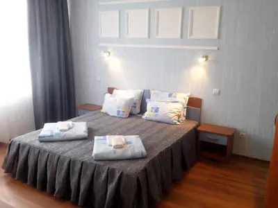 a bedroom with a bed with two pillows on it at Aquamarine in Sozopol