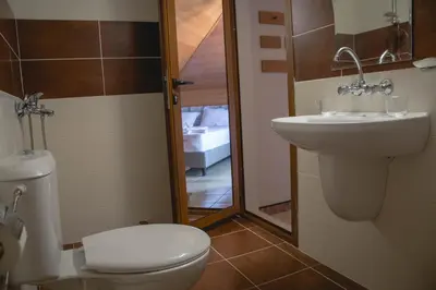 a bathroom with a toilet and a sink at Prince Cyril Hotel in Nesebar