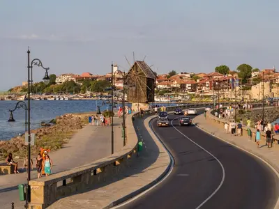 a road with cars on it next to a beach at Prince Cyril Hotel in Nesebar