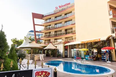 a hotel with a swimming pool in front of a building at Hotel St Valentine all inclusive in Sunny Beach