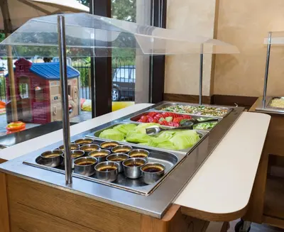 a buffet with a tray of vegetables and cupcakes at Hotel St Valentine all inclusive in Sunny Beach