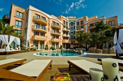 a resort with a swimming pool and a building at Aphrodite Rose Apartment in Sunny Beach