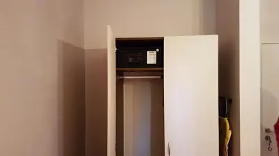 a microwave sitting on top of a shelf in a room at Aphrodite Rose Apartment in Sunny Beach