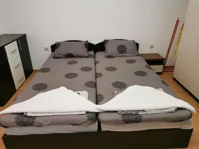 a bed with two pillows on it in a room at Aphrodite Rose Apartment in Sunny Beach