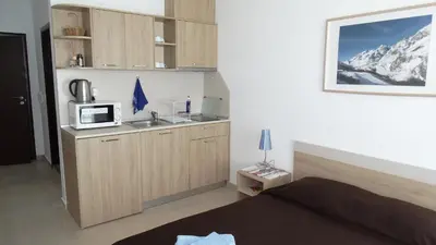 a room with a kitchen with a sink and a microwave at Akrotiria Beach Apart Complex in Nesebar