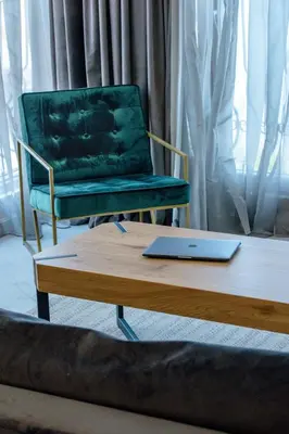 a laptop sitting on a coffee table next to a chair at Relax Sozopol in Sozopol