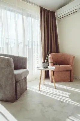 a living room with a couch and a chair and a table at Relax Sozopol in Sozopol