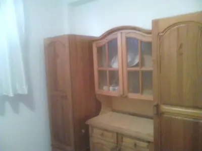 a wooden cabinet in the corner of a room at GoodRest Nesebar in Nesebar