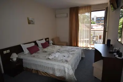a bedroom with a bed with towels on it at Kandrovi Sozopol in Sozopol