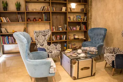 a living room with two chairs and a table at Hotel Golden Tulip Varna in Varna City