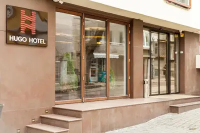 a hico hotel building with a sign on the facade at Hugo Hotel in Varna City