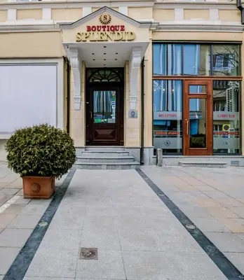 a building with a door and a plant in front of it at Boutique Splendid Hotel in Varna City