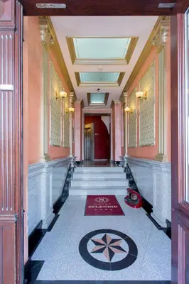 a hallway of a building with a rug on the floor at Boutique Splendid Hotel in Varna City