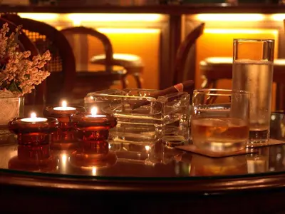 a table with candles and glasses on a table at Mirage Hotel in Burgas City