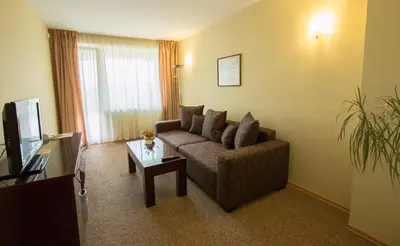 a living room with a couch and a coffee table at Hotel Divesta - self check in in Varna City