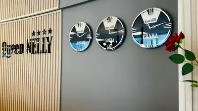 a group of clocks hanging on a wall at Queen Nelly in Primorsko