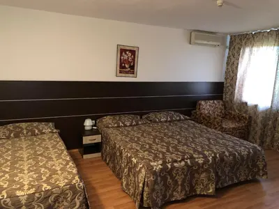 a hotel room with two beds and a window at Hotel Zora in Sunny Beach