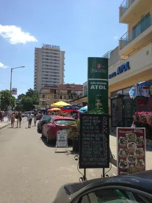 a street with cars parked in a parking lot at Hotel Atol in Sunny Beach