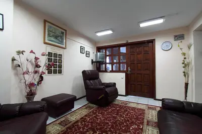 a living room with a couch and a chair and a door at Family Hotel Verona in Sozopol
