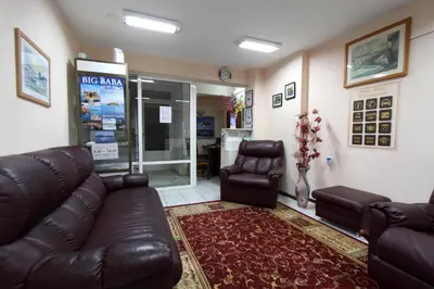 a living room with a leather couch and two chairs at Family Hotel Verona in Sozopol