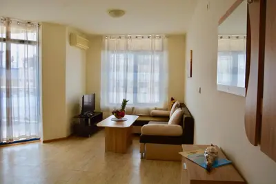 a living room with a couch and a table at Rainbow 1 Holiday Complex in Sunny Beach