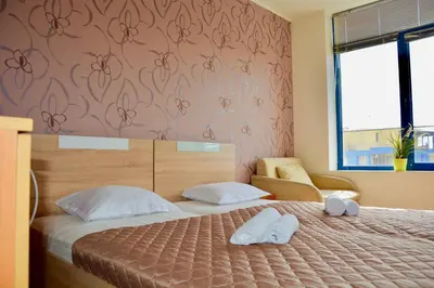 a bedroom with a bed with two towels on it at Rainbow 1 Holiday Complex in Sunny Beach
