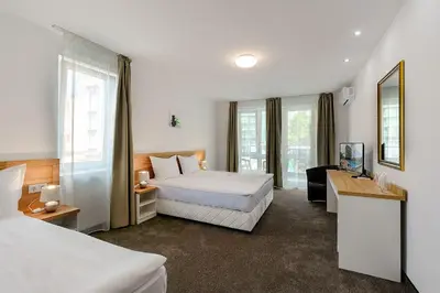 a hotel room with a bed and a couch at Sveti Dimitar Hotel in Primorsko