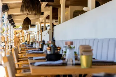 a row of tables and chairs in a restaurant at Selena Beach Family Hotel - All Inclusive Light in Sozopol