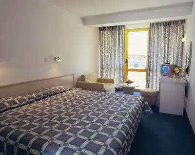 a hotel room with a bed and a window at Continental Park Hotel in Sunny Beach