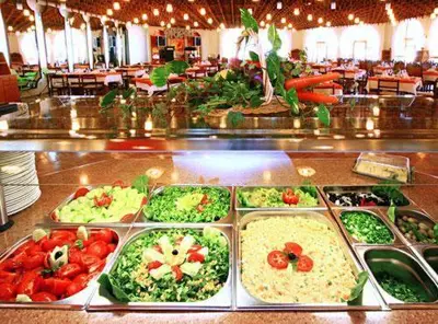a buffet filled with different types of vegetables in trays at Continental Park Hotel in Sunny Beach