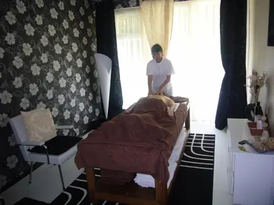 a man standing next to a bed in a room at Continental Park Hotel in Sunny Beach