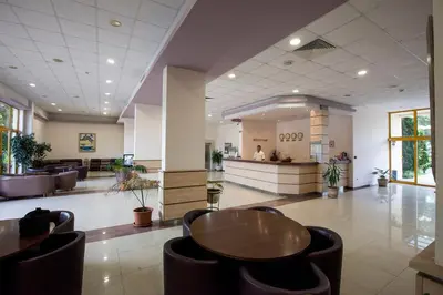 a hospital lobby with a table and chairs at Continental Park Hotel in Sunny Beach
