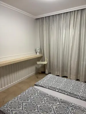 a hotel room with two beds and a window at Santa Marina Apartment 513 in Sozopol