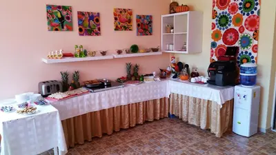 a kitchen with two tables and a counter at Family Hotel Avenue in Kiten