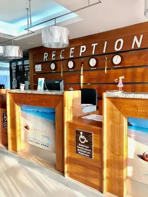 a restaurant with a counter with clocks on the wall at Obzor Beach Resort in Obzor