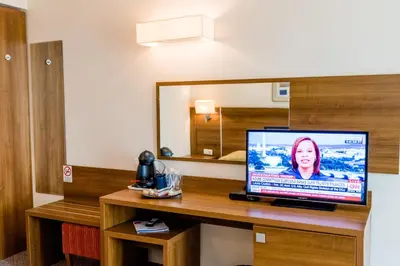 a television on a desk in a hotel room at Hotel Burgas in Burgas City