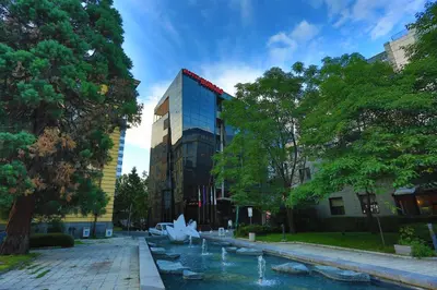 a building with a fountain in front of a building at Hotel Burgas in Burgas City
